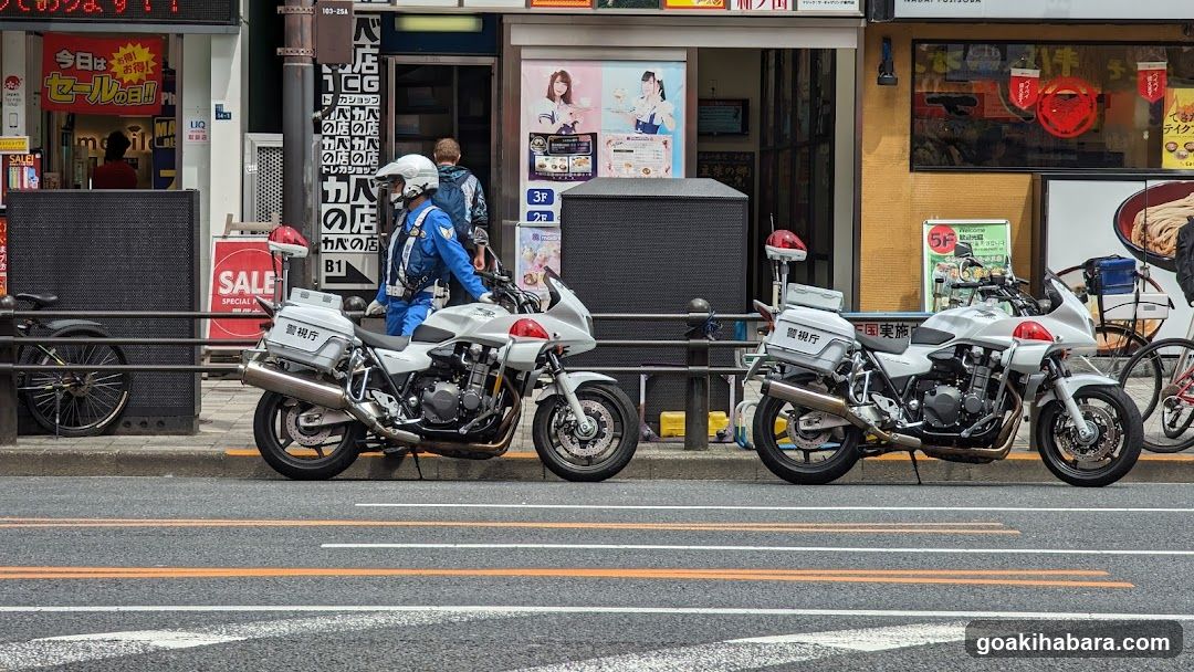 Motorcycles parked on street with shop background