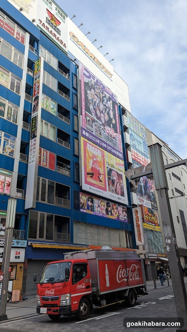 Street scene with Coca-Cola truck and anime posters
