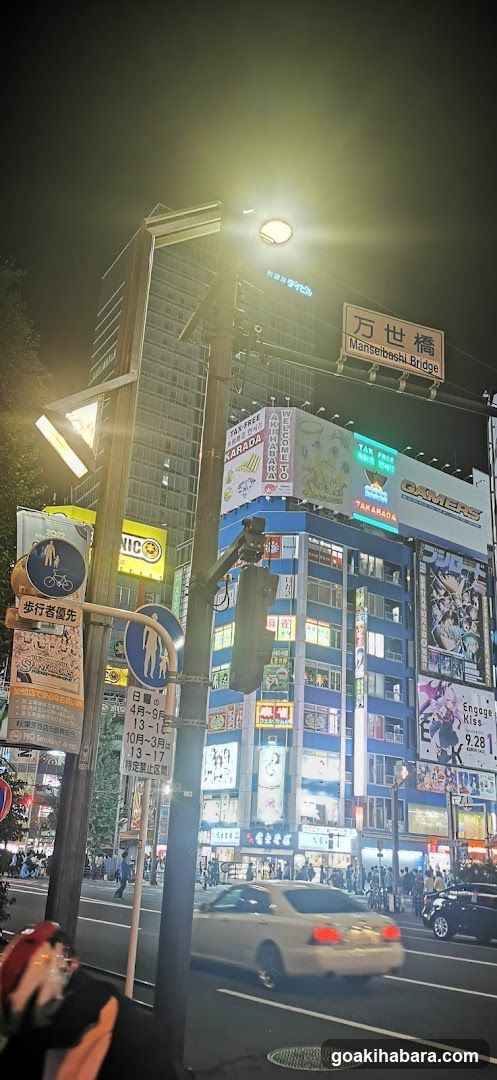 Night street scene with illuminated buildings and traffic lights