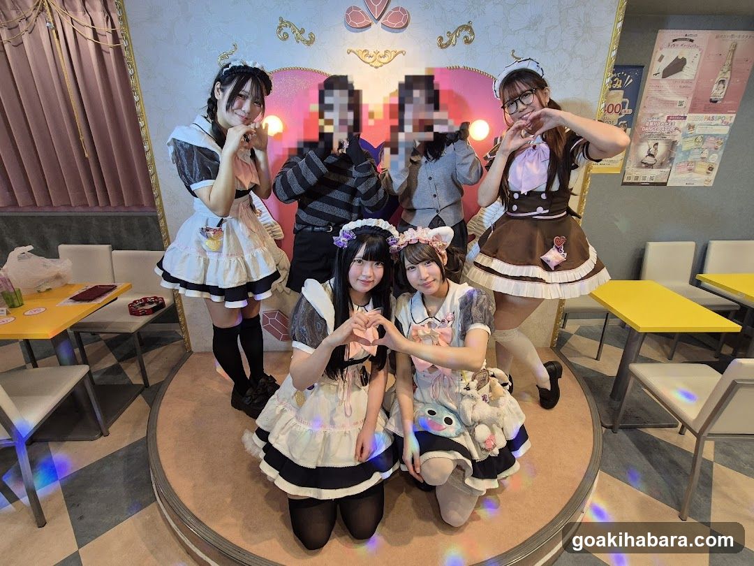 Group of people in maid outfits posing indoors