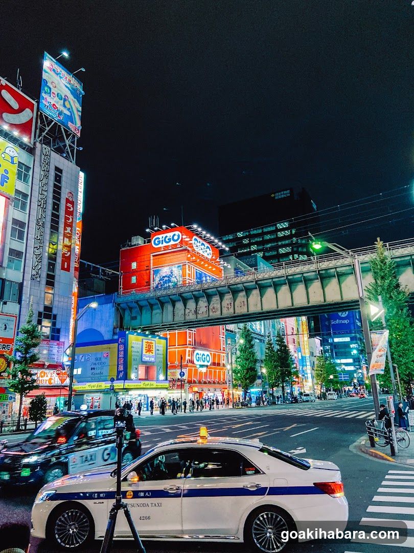Night street scene with taxis and illuminated buildings