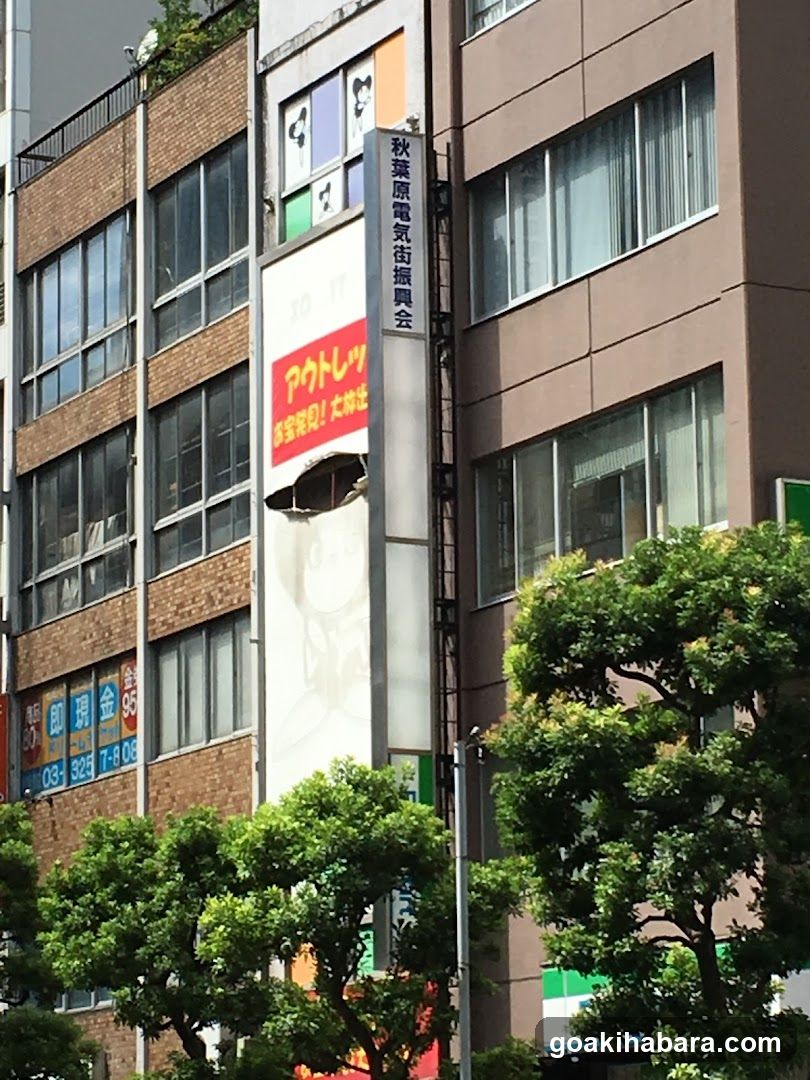 Building Exterior with Signage and Damaged Wall