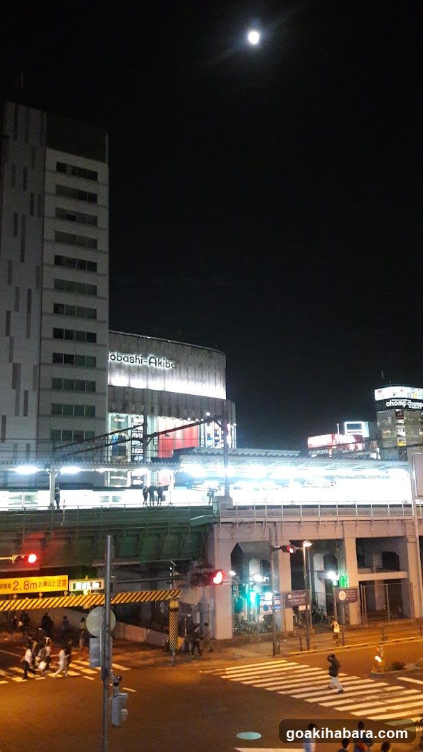 Night street scene with illuminated building and train station