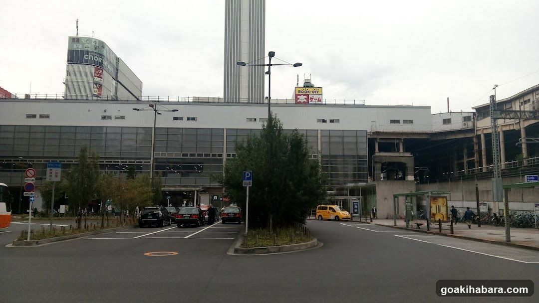 Station Exterior with Vehicles and Signage