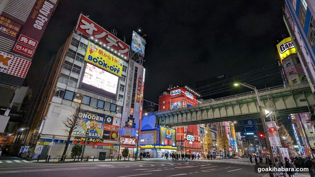 Night street scene with illuminated billboards and signs