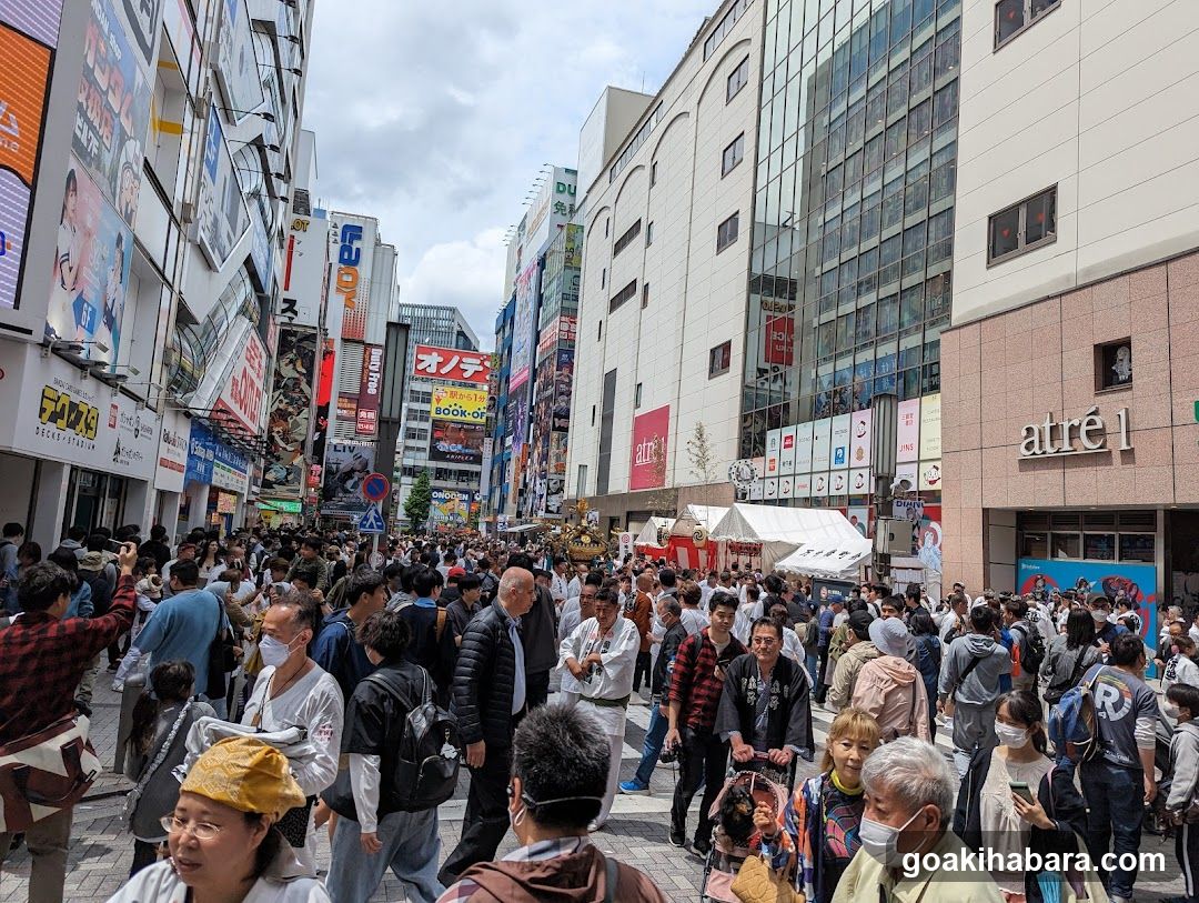 Crowded Street Scene with Shops and Signs