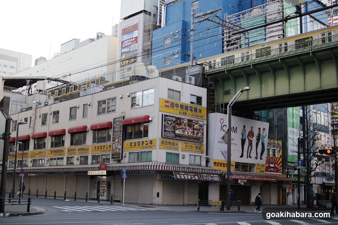 Urban Street Scene with Shops and Overhead Tracks