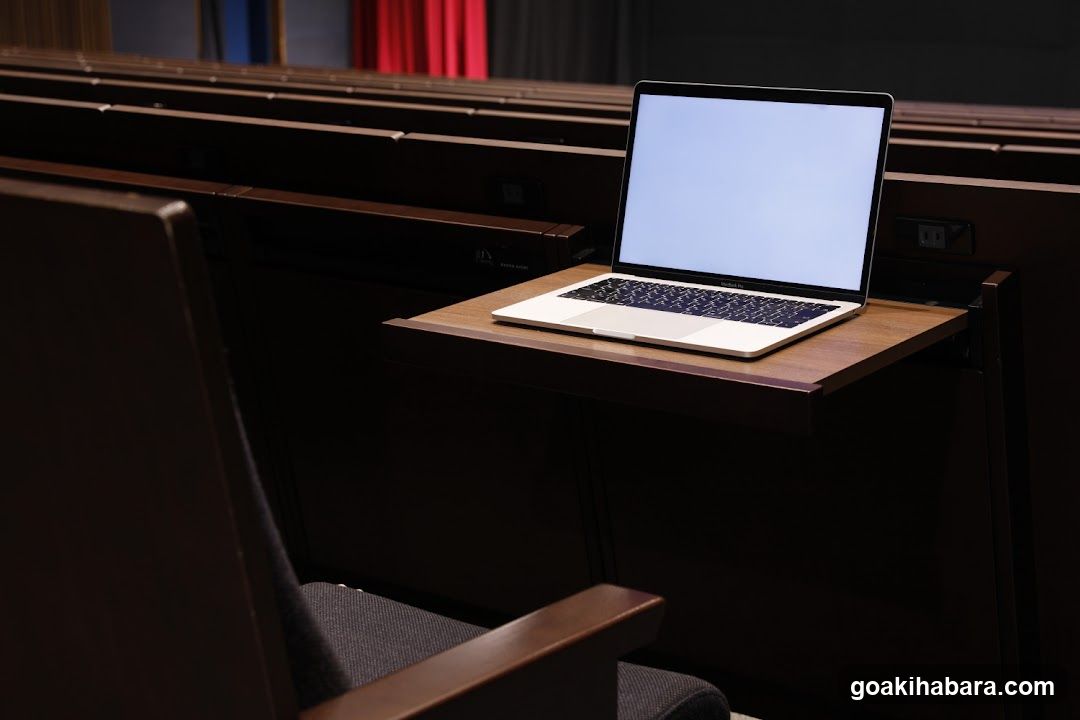 Laptop on a desk in an auditorium