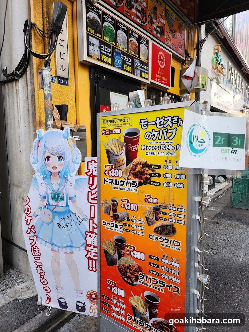 Anime Character Poster and Menu Board Outside Restaurant