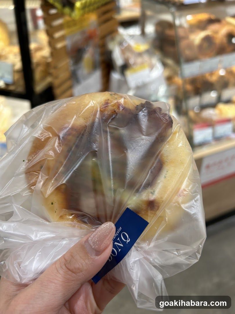 Hand holding packaged bun in bakery
