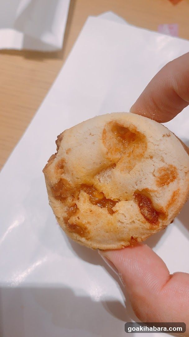 Hand holding a small pastry