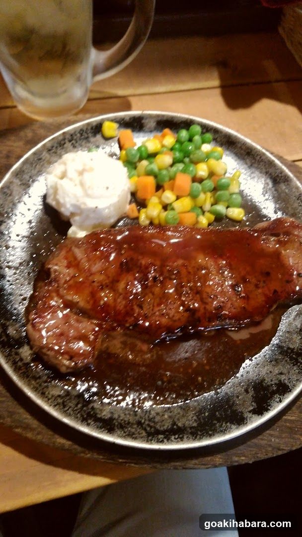 Steak with sides on a dark plate