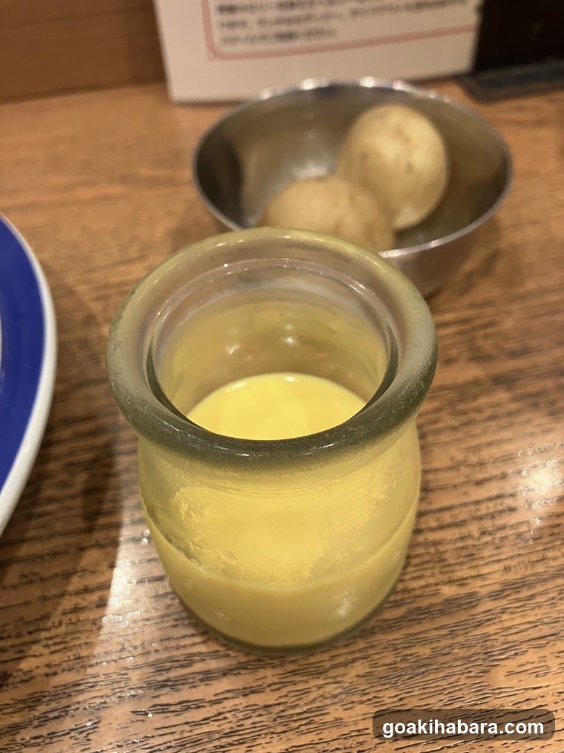Yellow Drink and Dumplings on Wooden Table