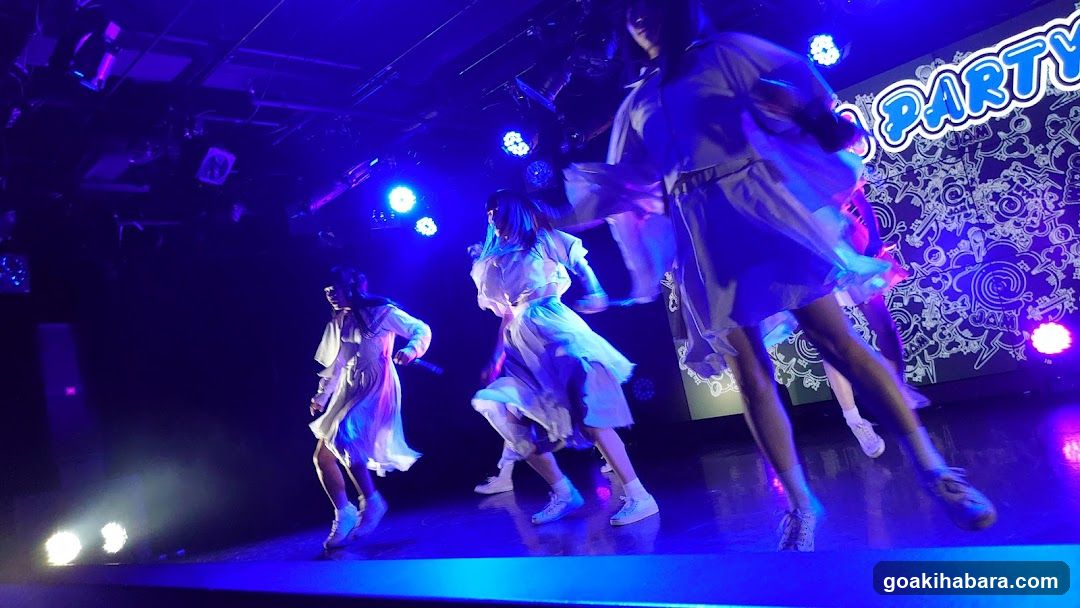 Stage Performance with Performers in White Outfits