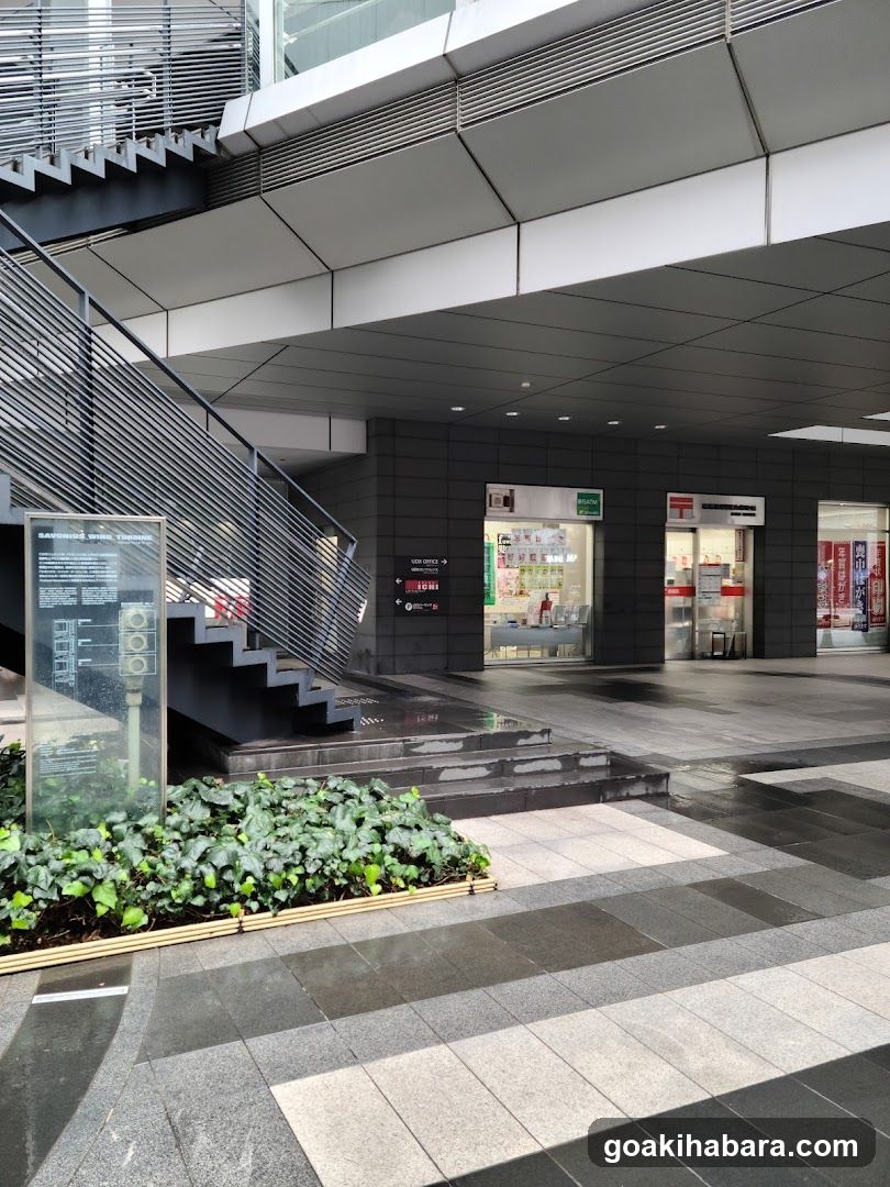 Modern Building Entrance with Stairs and Shops