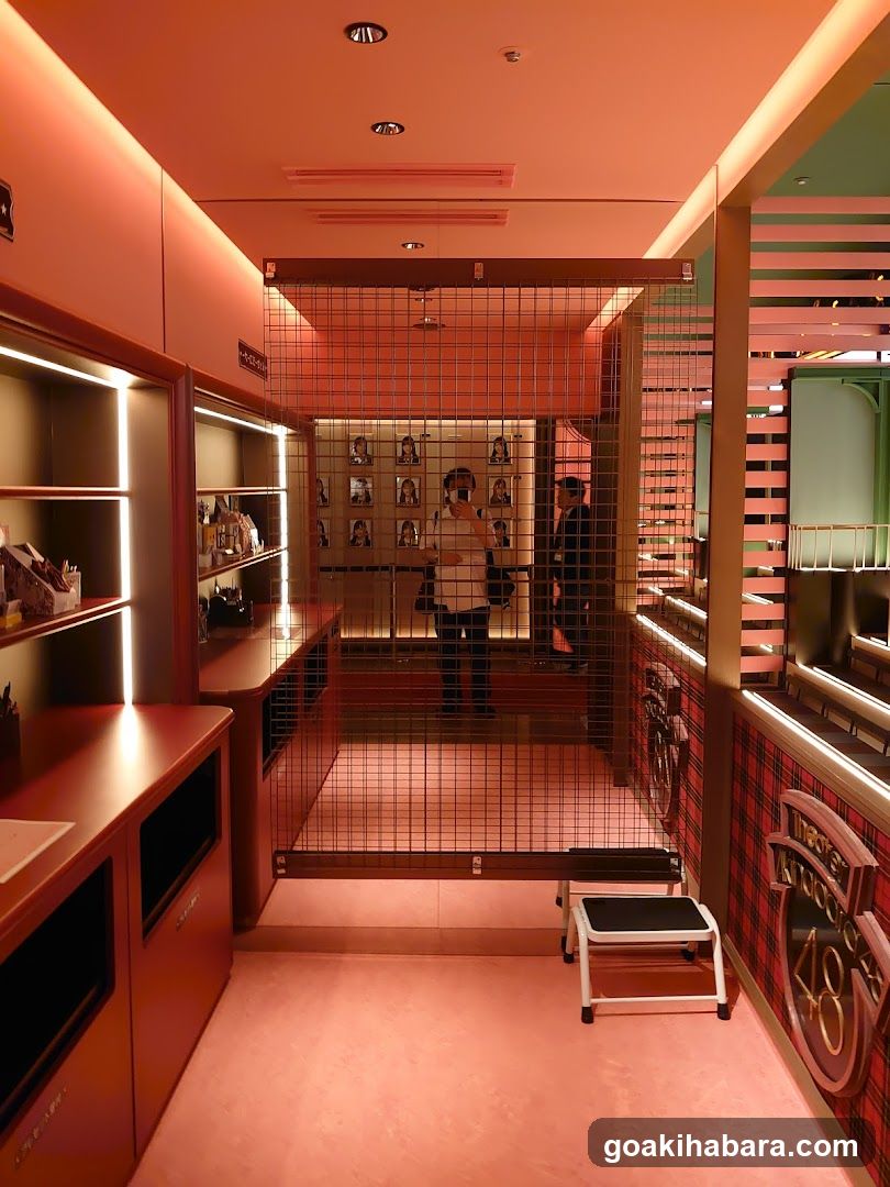 Interior of a modern retail space with pink lighting and grid partitions.