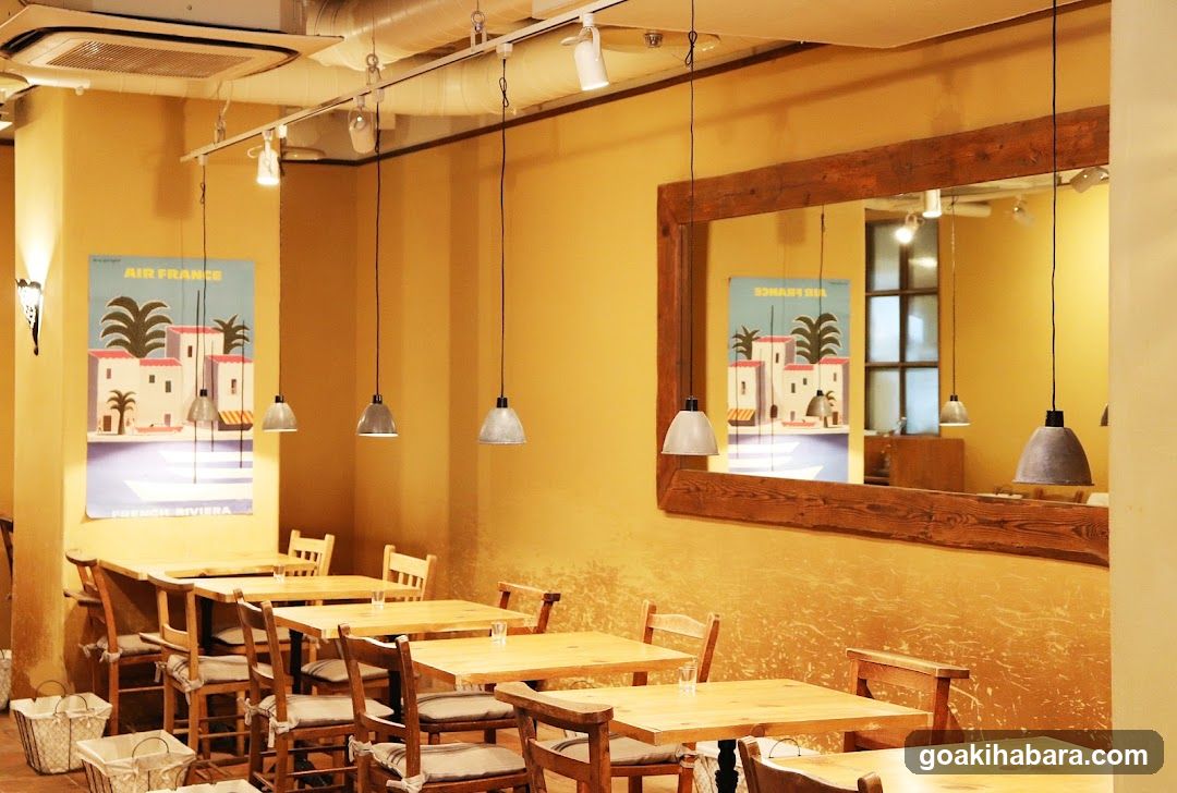 Interior of a cozy café with yellow walls and wooden furniture