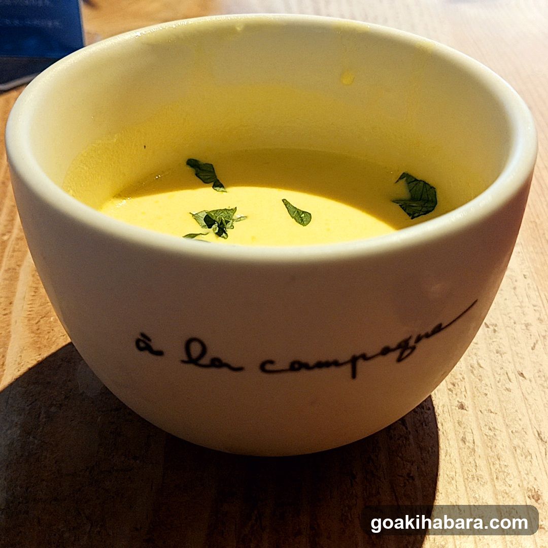 Bowl of Yellow Soup with Herbs