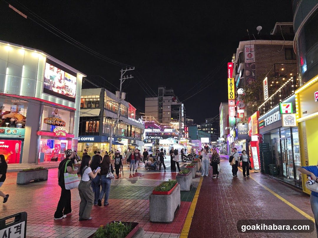Night Street Scene with Shops and Crowds
