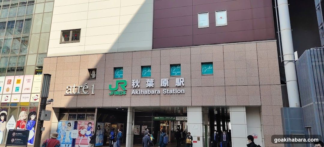 Exterior facade of Akihabara Station with visible signage including 'atré1', JR logo, and station name in Japanese and English. Storefronts are partially visible at ground level.