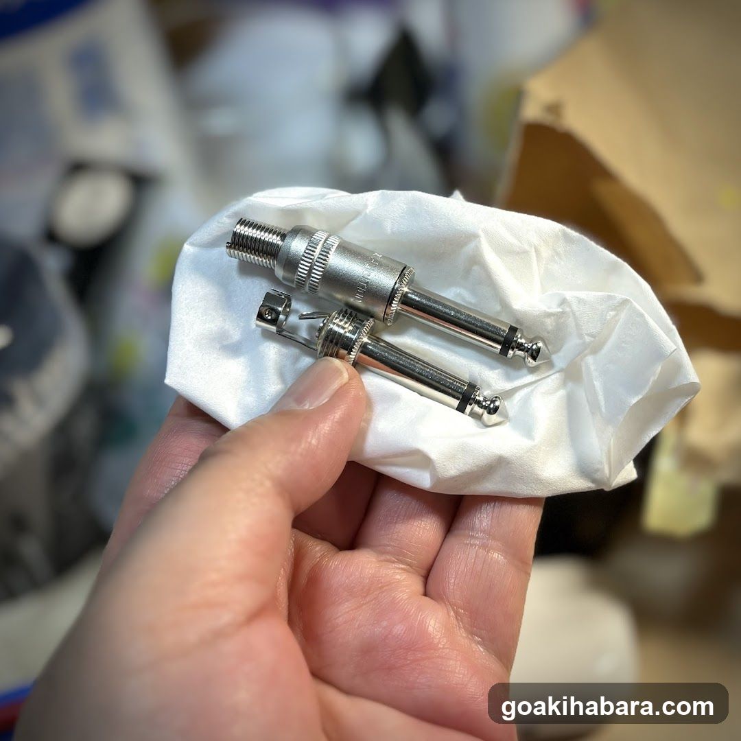 Hand holding metal connectors on tissue paper