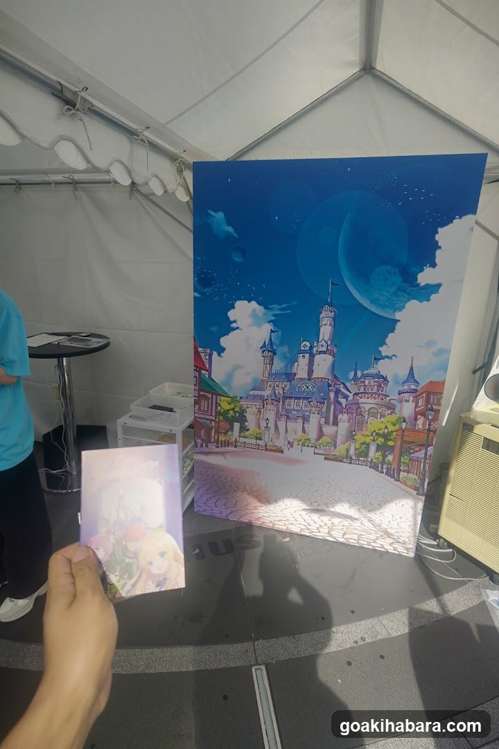 Anime-style poster and merchandise display under tent