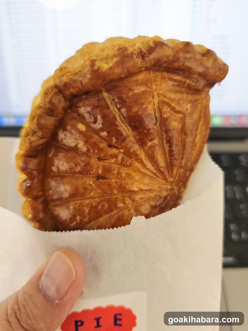 Handheld pastry in paper wrapper
