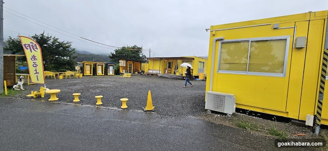 Yellow Outdoor Area with Containers and Signage
