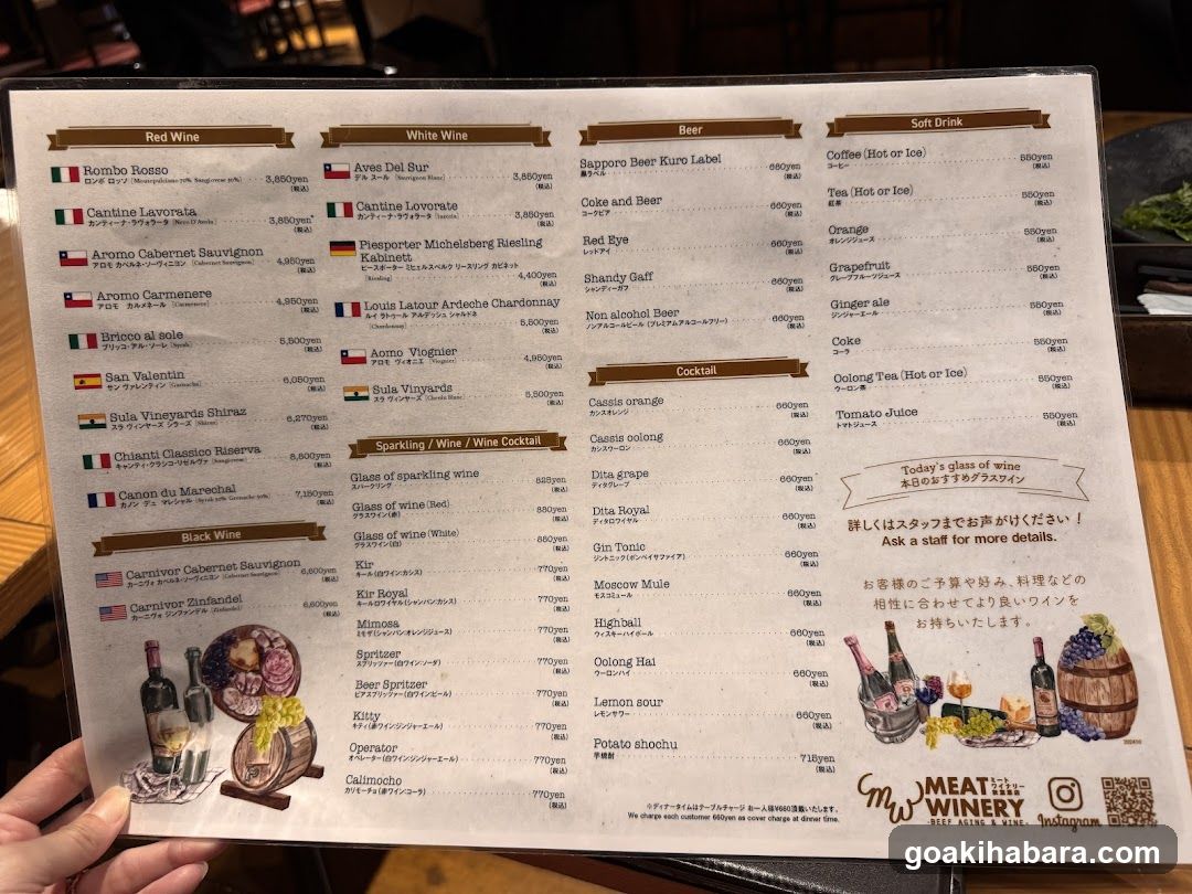 A printed menu displaying wine, beer, soft drinks, and cocktails with prices in yen.
