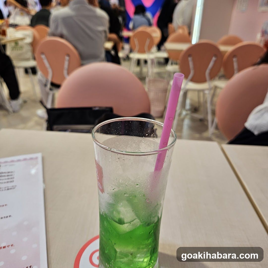 Green drink with pink straw in a glass