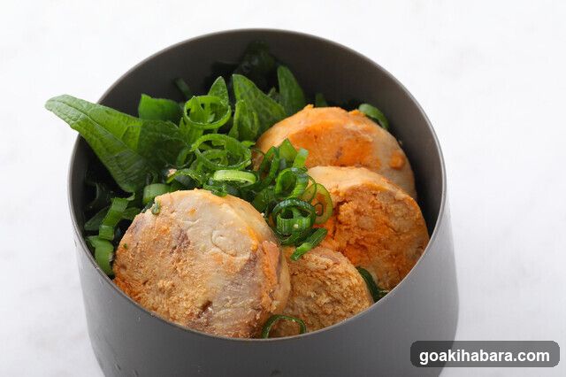 Bowl of Food with Greens and Meatballs