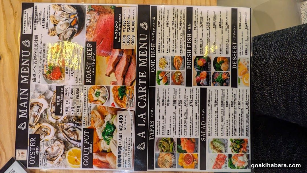 A printed menu board featuring sections like Main Menu, Oyster Pot, Roast Beef, One Dish, Fresh Fish, Salad, and Dessert with prices in yen.
